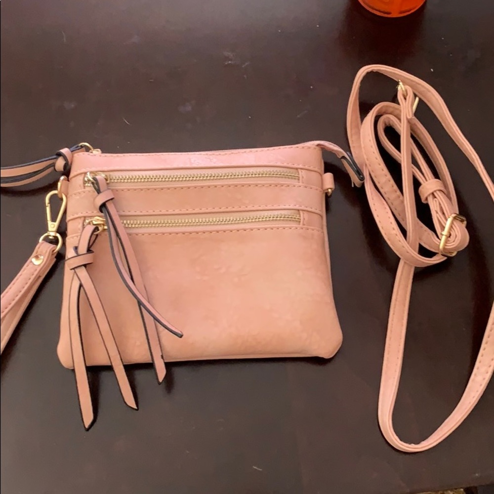 Light pink wristlet/ adjustable cross body